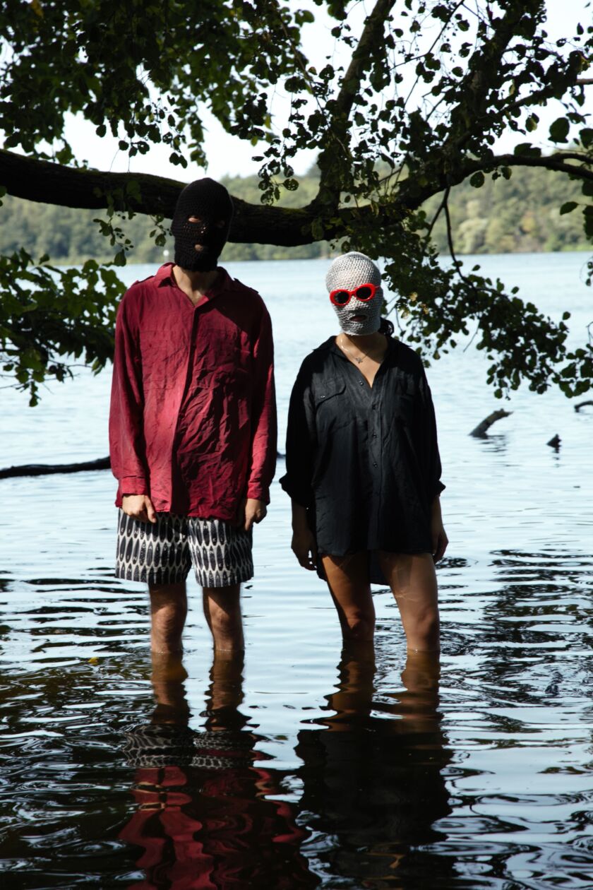 two people in the lake wearing balaclavas